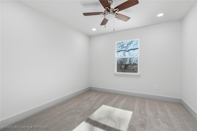 empty room featuring light colored carpet and ceiling fan