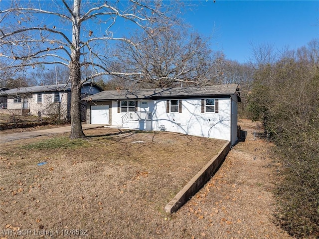 ranch-style house with a garage and a front yard