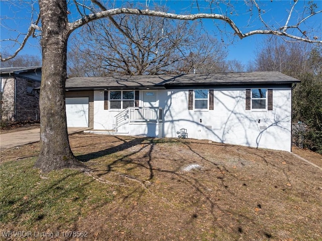 single story home featuring a garage and a front lawn