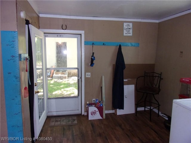 doorway to outside with crown molding, washer / dryer, wood finished floors, and a wealth of natural light