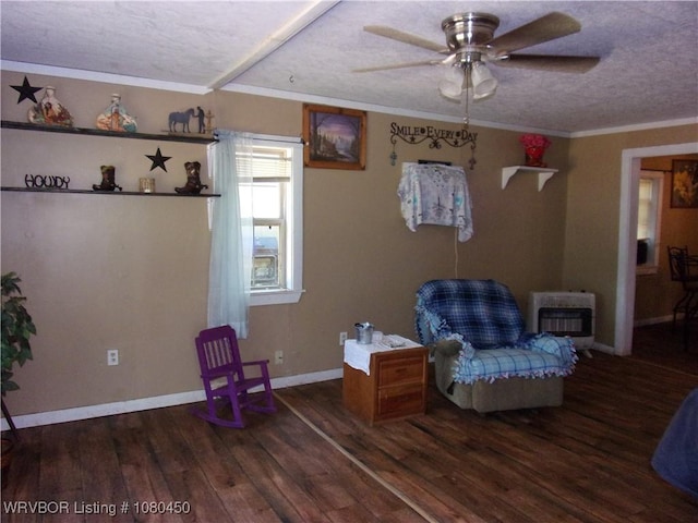 sitting room featuring crown molding, a textured ceiling, a ceiling fan, heating unit, and wood finished floors