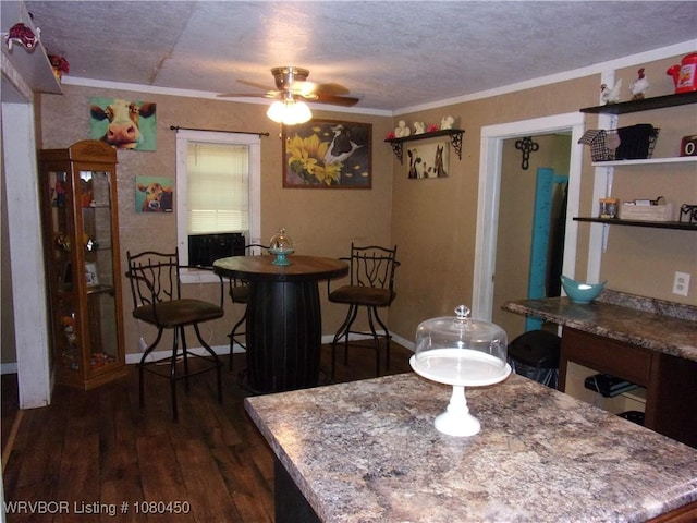 dining area with a ceiling fan, a textured ceiling, crown molding, dark wood finished floors, and baseboards