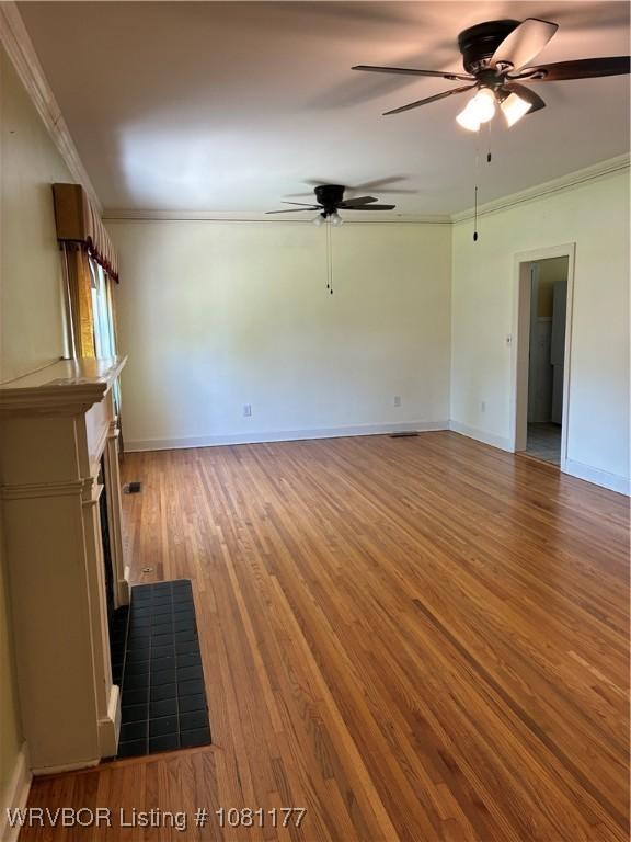 2227 S Q St, Fort Smith, AR 72901 - unfurnished living room featuring a ceiling fan, crown molding, light wood-style floors, a fireplace with flush hearth, and baseboards