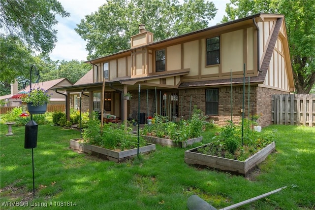 2508 Roxbury Ln, Fort Smith, AR 72908 - rear view of house featuring a vegetable garden, a chimney, stucco siding, and brick siding