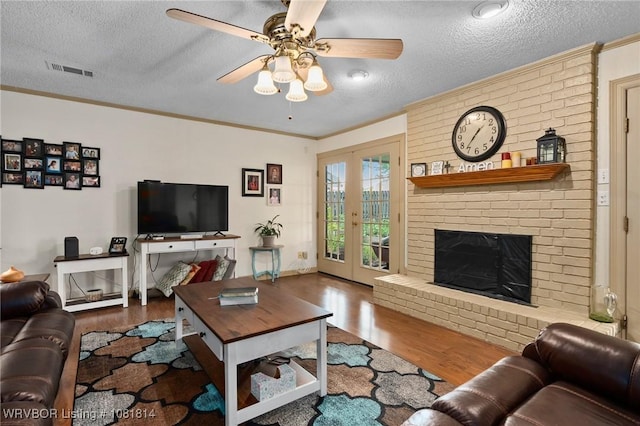 2508 Roxbury Ln, Fort Smith, AR 72908 - living area with wood finished floors, a textured ceiling, a ceiling fan, crown molding, and a fireplace