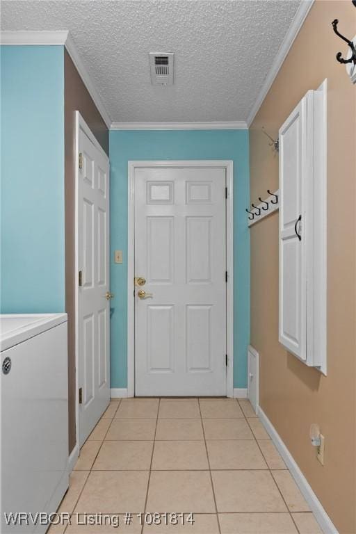 2508 Roxbury Ln, Fort Smith, AR 72908 - entryway with washer / clothes dryer, light tile patterned floors, a textured ceiling, and ornamental molding