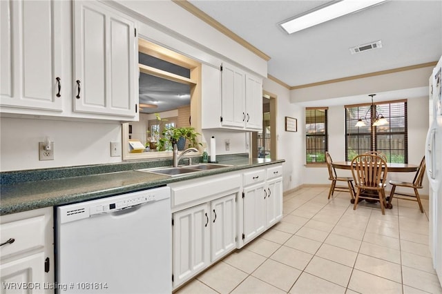 2508 Roxbury Ln, Fort Smith, AR 72908 - kitchen with white dishwasher, dark countertops, light tile patterned floors, ornamental molding, and white cabinetry