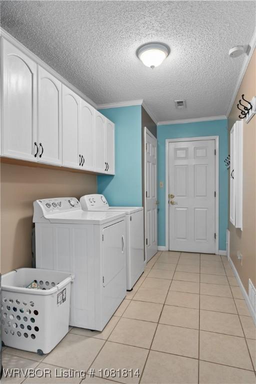 2508 Roxbury Ln, Fort Smith, AR 72908 - washroom with washer and dryer, light tile patterned floors, a textured ceiling, ornamental molding, and cabinet space