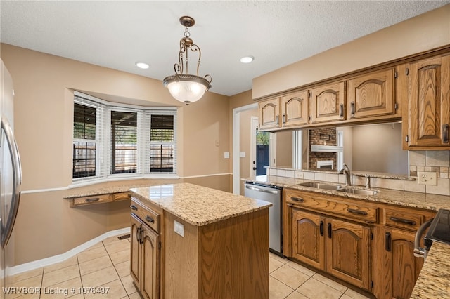 kitchen featuring pendant lighting, sink, stainless steel dishwasher, light tile patterned floors, and a kitchen island