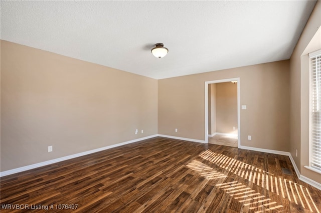 empty room featuring dark hardwood / wood-style floors