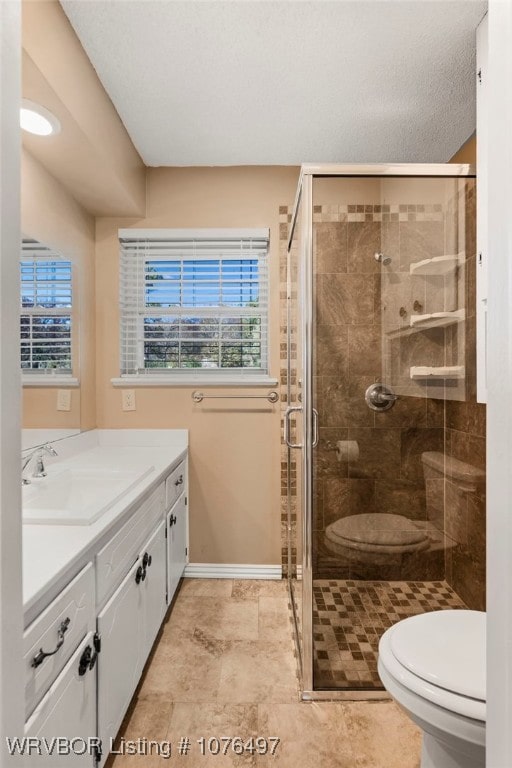 bathroom featuring vanity, toilet, and walk in shower