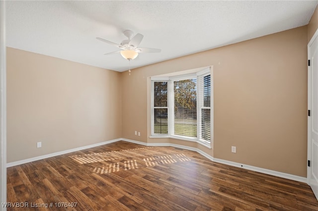 unfurnished room with ceiling fan and dark hardwood / wood-style floors