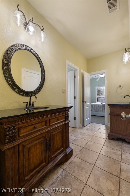 bathroom featuring ceiling fan, tile patterned flooring, and vanity