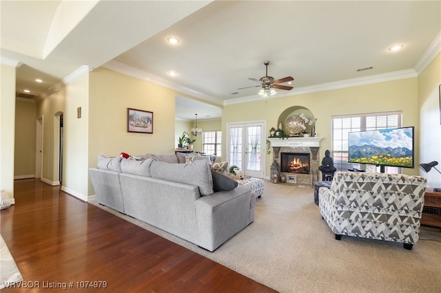 living room featuring hardwood / wood-style floors, plenty of natural light, crown molding, and ceiling fan