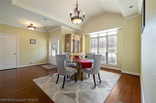 dining room featuring ornamental molding, dark hardwood / wood-style flooring, lofted ceiling, and a notable chandelier