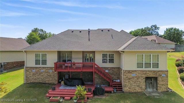 rear view of property featuring a deck and a yard