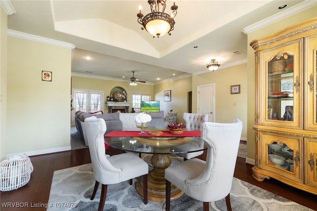 dining space with lofted ceiling, ceiling fan, dark hardwood / wood-style floors, and ornamental molding