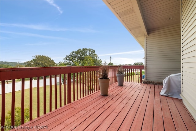 wooden terrace featuring a yard