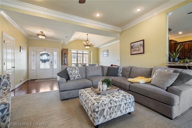 living room with wood-type flooring, ornamental molding, lofted ceiling, and a notable chandelier