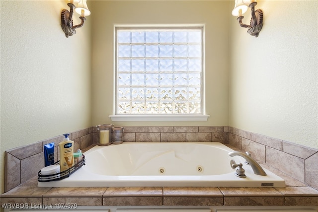 bathroom featuring a healthy amount of sunlight and a tub to relax in