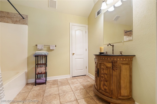 bathroom featuring tile patterned flooring, vanity, shower / bath combination, and vaulted ceiling