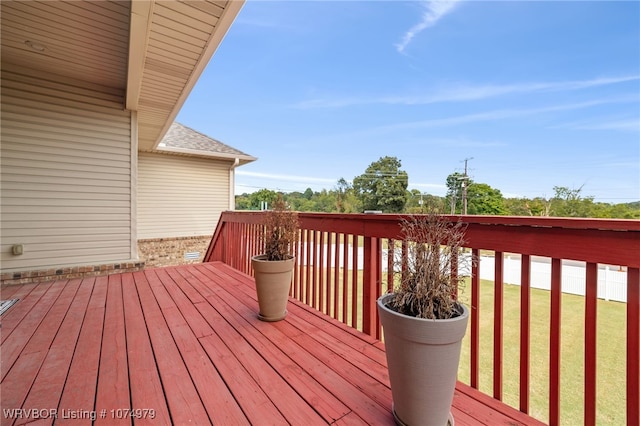 wooden deck with a lawn