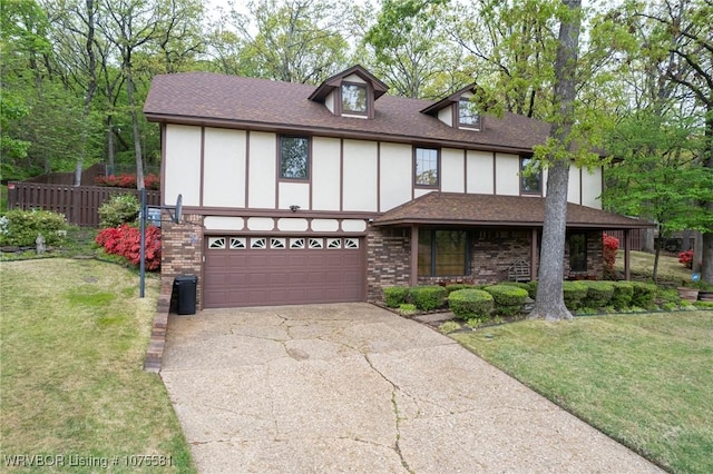 tudor home with a garage and a front yard