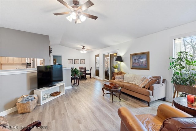 living room featuring light hardwood / wood-style flooring, ceiling fan, and vaulted ceiling