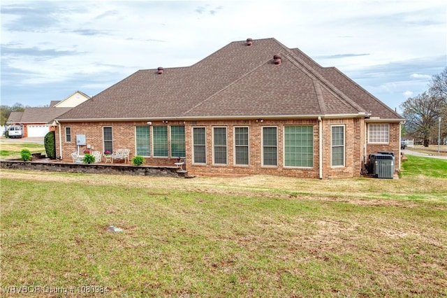 1101 Eagle Crest Dr, Alma, AR 72921 - rear view of property featuring a lawn, brick siding, and central AC unit