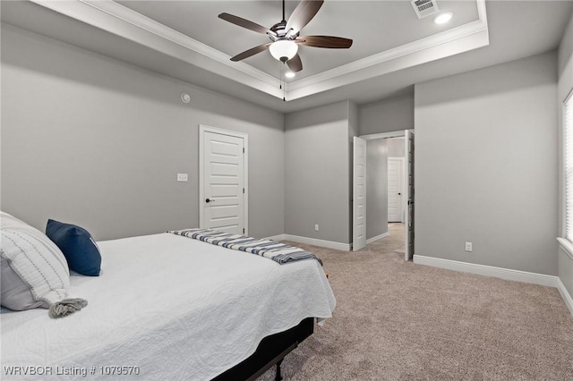 bedroom featuring visible vents, crown molding, baseboards, light carpet, and a raised ceiling