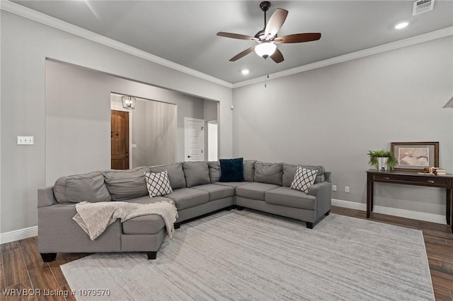 living area with visible vents, ornamental molding, baseboards, and dark wood-style flooring