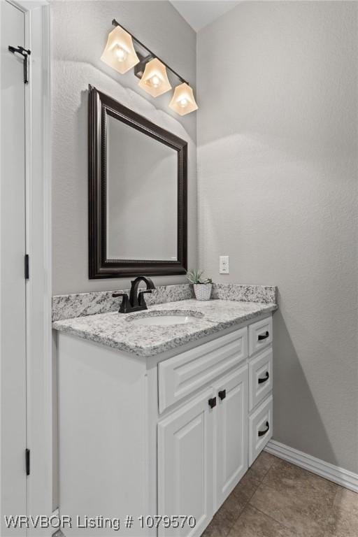 bathroom featuring vanity and baseboards