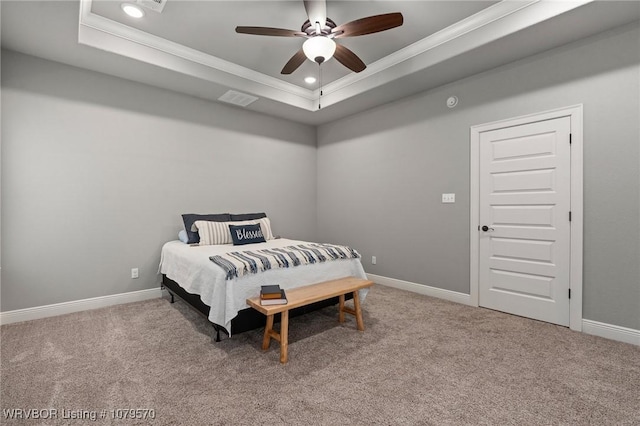 bedroom with a raised ceiling, carpet, and ornamental molding