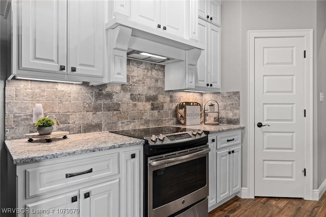 kitchen featuring stainless steel electric stove, white cabinetry, and dark wood-type flooring