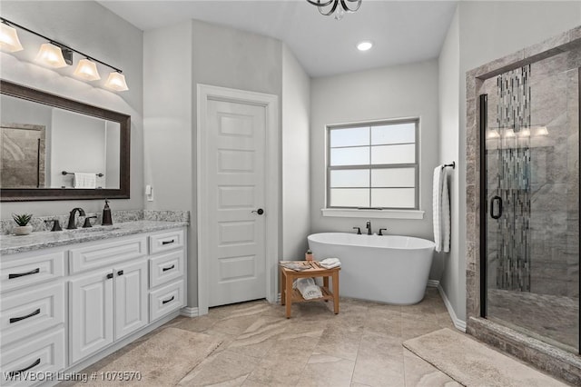 bathroom with vanity, a shower stall, and a freestanding bath