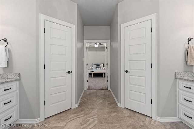 bathroom featuring baseboards and vanity