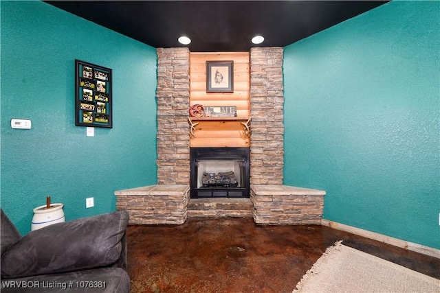 living room featuring a fireplace and concrete floors