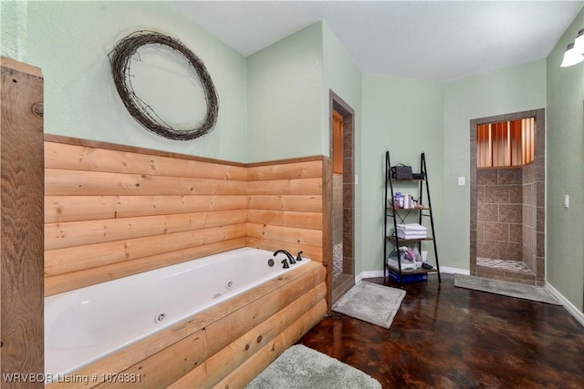 bathroom with concrete flooring and shower with separate bathtub