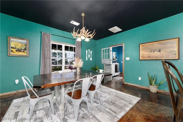 dining area featuring a notable chandelier