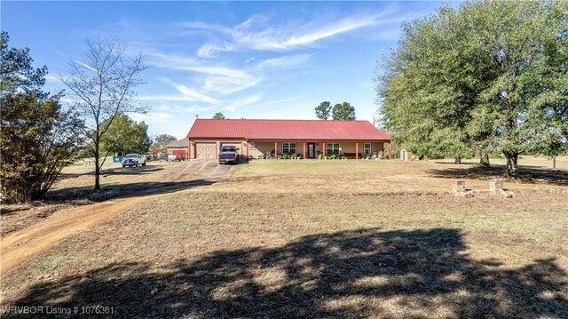 single story home with a garage and an outdoor structure