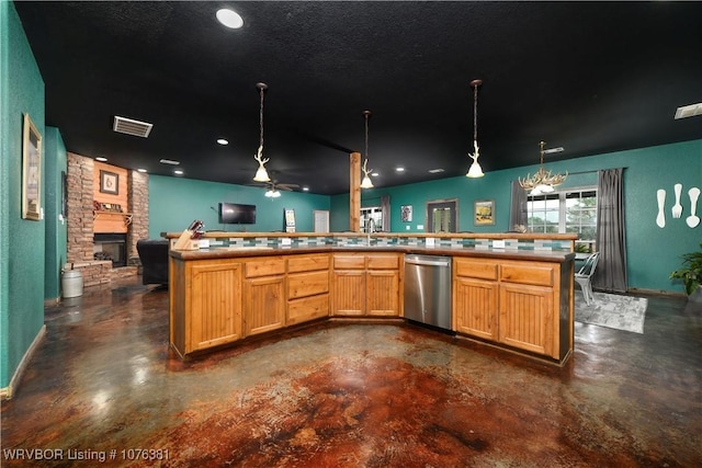 kitchen featuring stainless steel dishwasher, kitchen peninsula, pendant lighting, a fireplace, and ceiling fan with notable chandelier