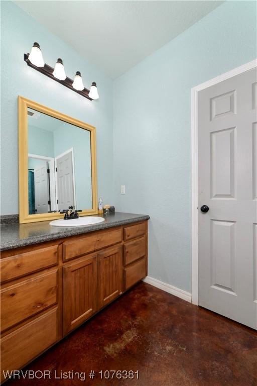 bathroom featuring vanity and concrete floors