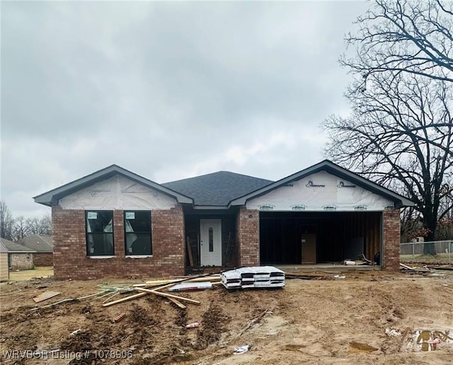 property in mid-construction featuring brick siding and an attached garage