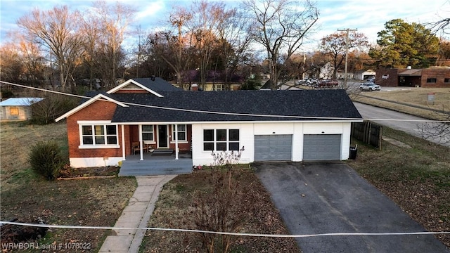 ranch-style house with a porch and a garage