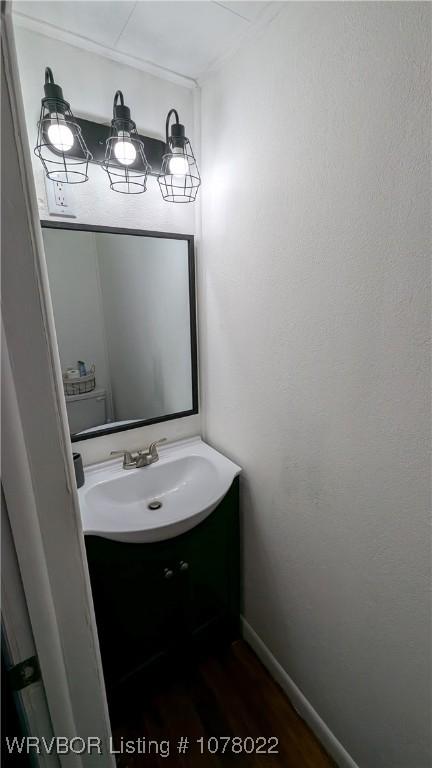 bathroom featuring vanity, toilet, and wood-type flooring