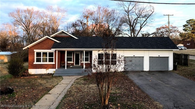 ranch-style house with a porch and a garage