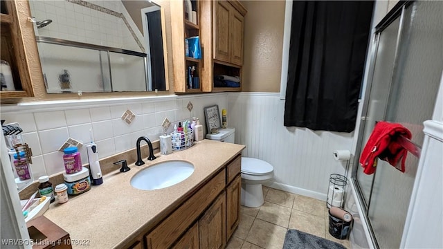 bathroom featuring backsplash, tile patterned floors, an enclosed shower, vanity, and toilet