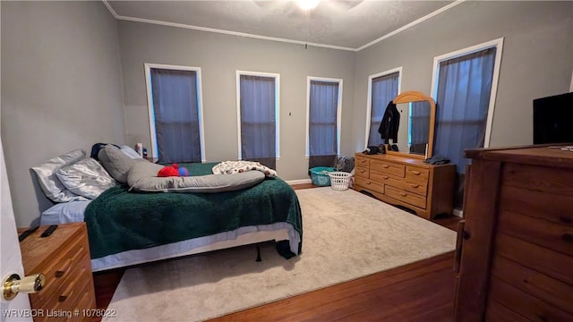 bedroom featuring dark hardwood / wood-style floors and ornamental molding