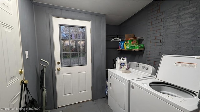 clothes washing area featuring separate washer and dryer