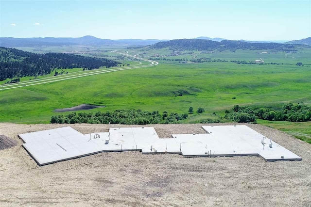 exterior space with a rural view and a mountain view